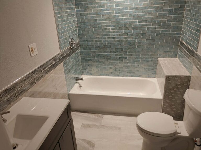 Gallery | Imperial Plumbing LLC Remodeled bathroom with new tub and tile surround