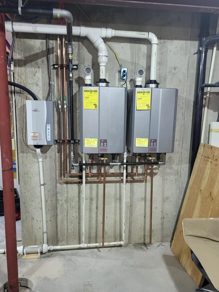 Gallery | Imperial Plumbing LLC Two tankless water heaters mounted in a utility room