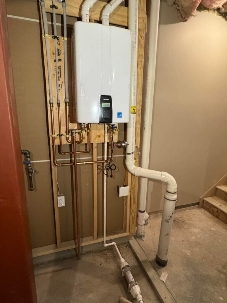 Gallery | Imperial Plumbing LLC Wall-mounted tankless water heater with new copper and PVC piping