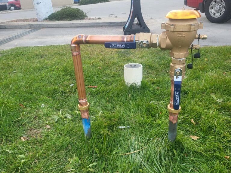 Gallery | Imperial Plumbing LLC Backflow preventer installed on an outdoor irrigation line