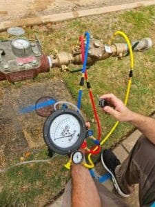 Gallery | Imperial Plumbing LLC Plumber pressure testing a line with test gauges